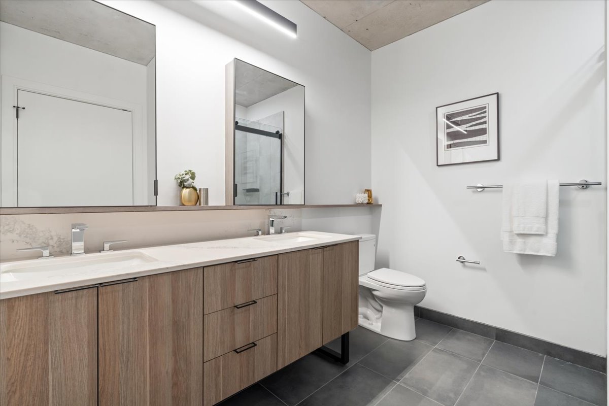 234 West Polk Street, Unit 3708 Chicago, IL 60607 - Photo 16 of 44 a bathroom with a double vanity sink toilet and a mirror