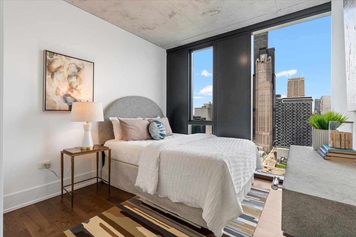 234 West Polk Street, Unit 3708 Chicago, IL 60607 - Photo 18 of 44 a bedroom with a bed and wooden floor