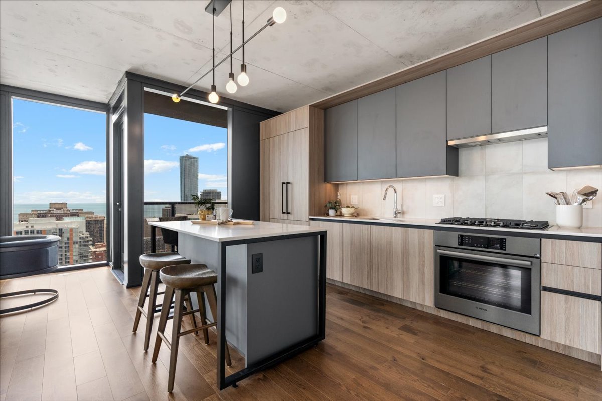 234 West Polk Street, Unit 3708 Chicago, IL 60607 - Photo 9 of 44 a kitchen with a sink cabinets and stainless steel appliances