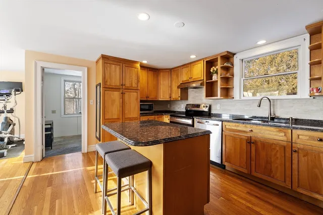 a kitchen with granite countertop a sink and cabinets