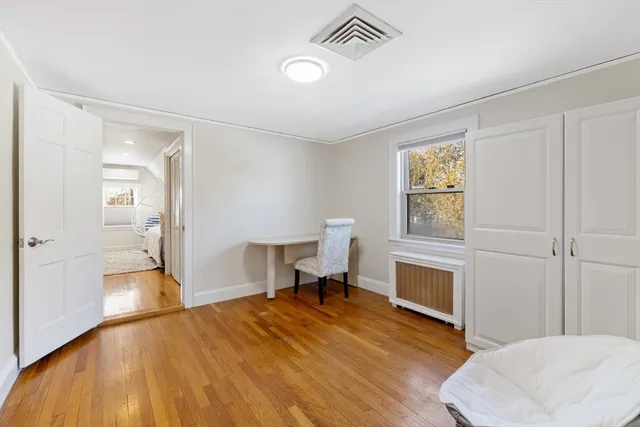 a bedroom with a bed and a chair