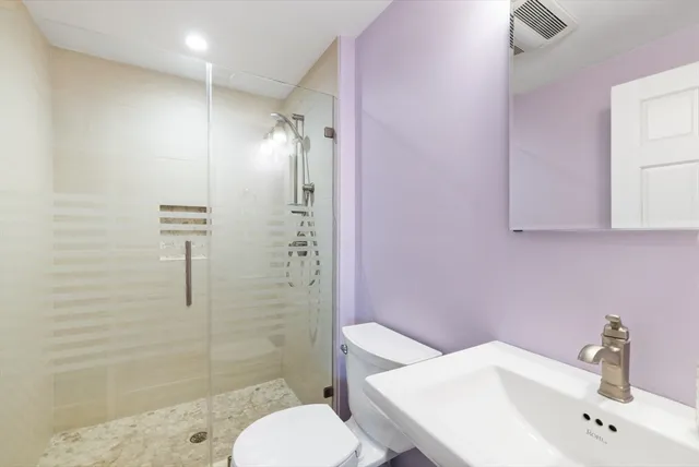 a bathroom with a sink toilet and shower