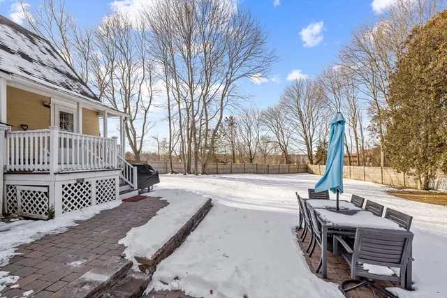 a view of a patio with a table chairs and a fire pit