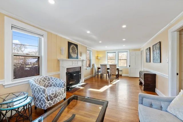 a living room with furniture fireplace and dining table