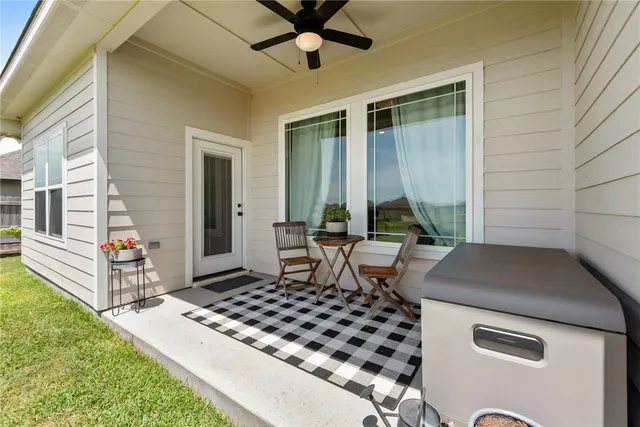 a table and chairs in front of a house