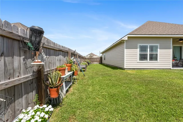 a view of a house with backyard and sitting area