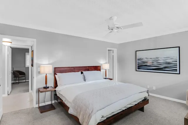 a bedroom with a bed and a painting