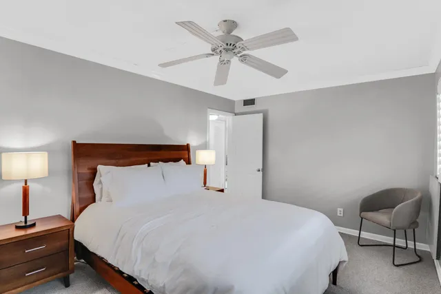 a bedroom with a bed and chair