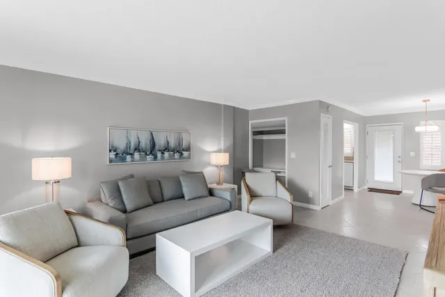 a living room with furniture and a large mirror