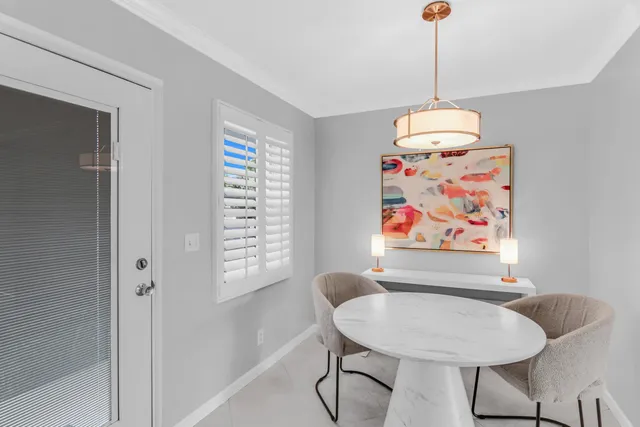 a view of a dining room with furniture wooden floor and a chandelier