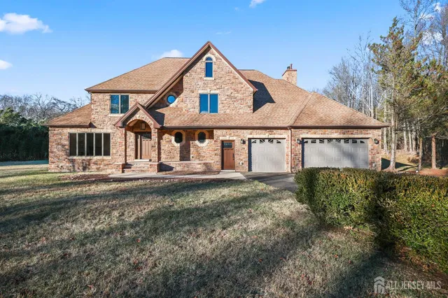 an empty room with wooden floor ceiling fan and windows
