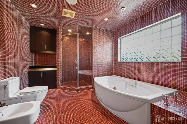 a bathroom with a toilet and a shower