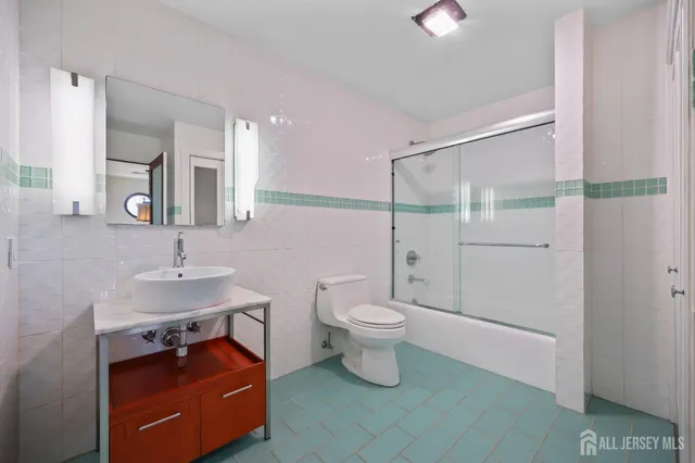 a view of a white house next to a road and yard