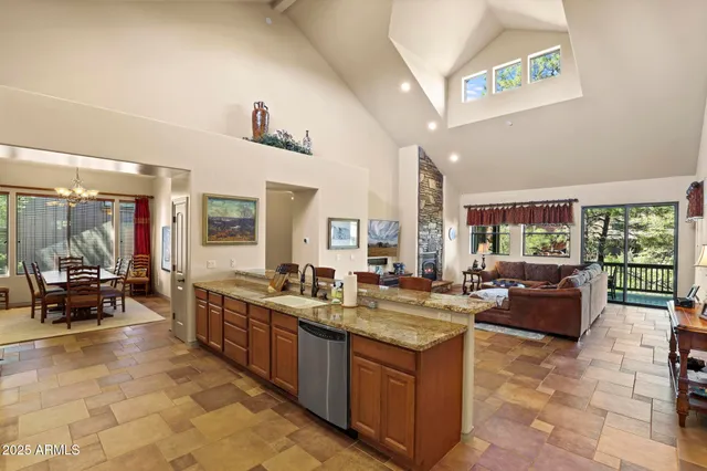 a kitchen with stainless steel appliances granite countertop a refrigerator and a stove