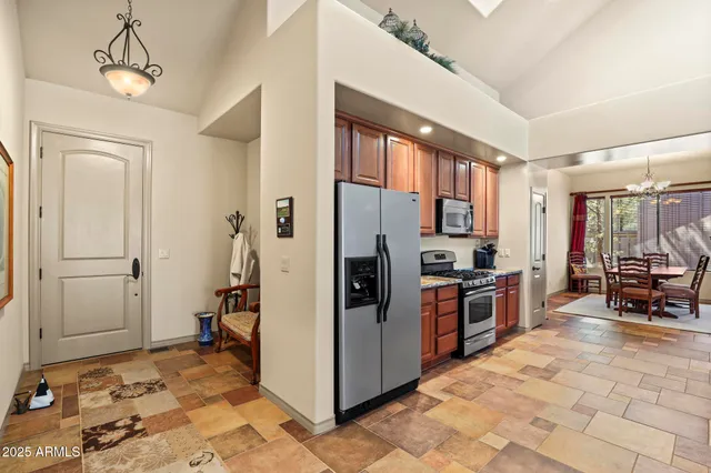 a large kitchen with stainless steel appliances granite countertop a stove a sink dishwasher and a refrigerator