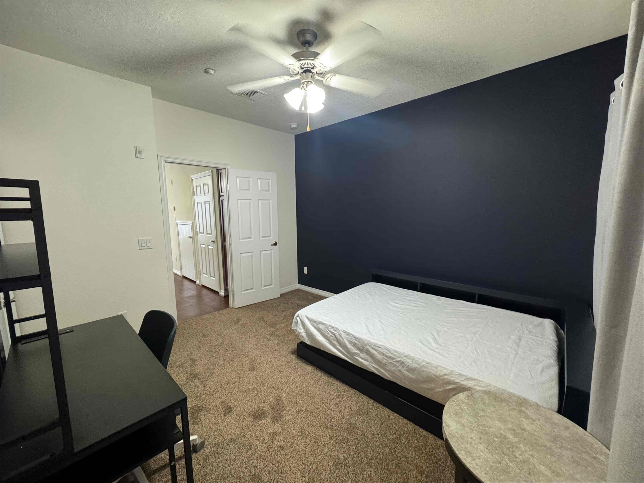 1198 Jones-Butler Road, Unit 2707 College Station, TX 77840 - Photo 12 of 24 a bedroom with a bed and a chandelier