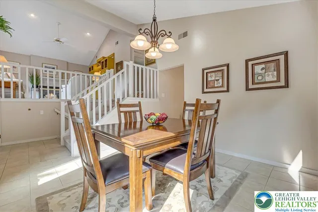 a dining room with furniture and chandelier