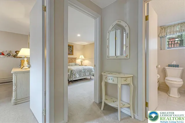 a en suite bathroom with a toilet sink and mirror
