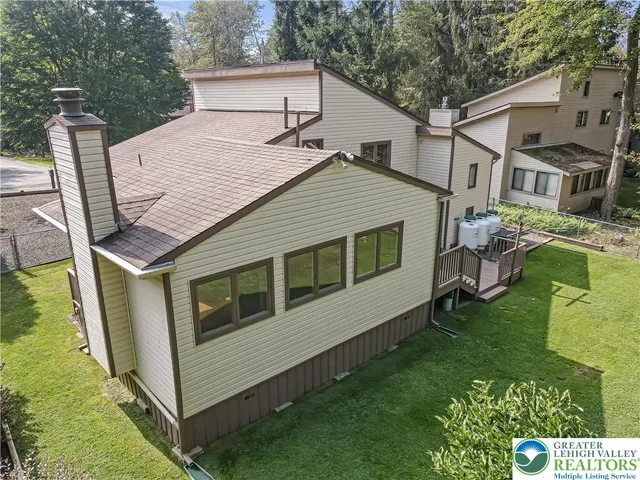 a aerial view of a house next to a big yard