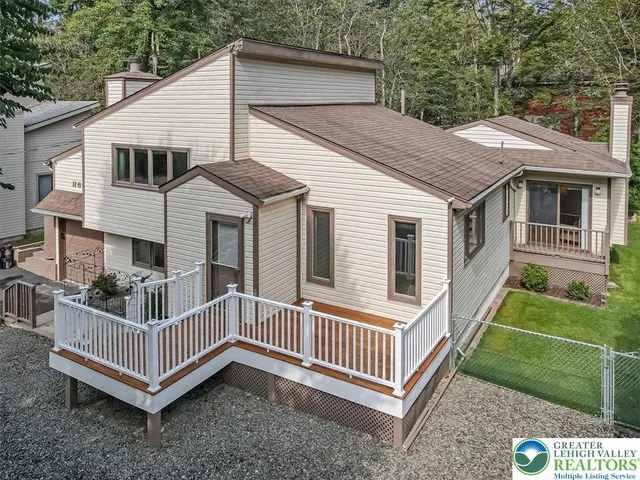 a view of a house with a yard and deck