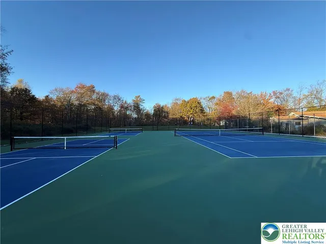 an aerial view of a house with a yard basket ball court and outdoor seating