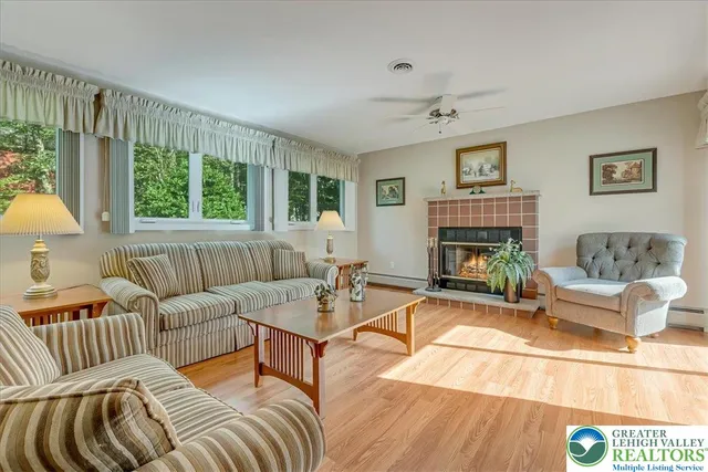 a living room with furniture and a fireplace