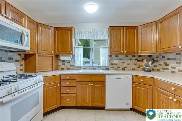 a kitchen with stainless steel appliances granite countertop a stove sink and cabinets