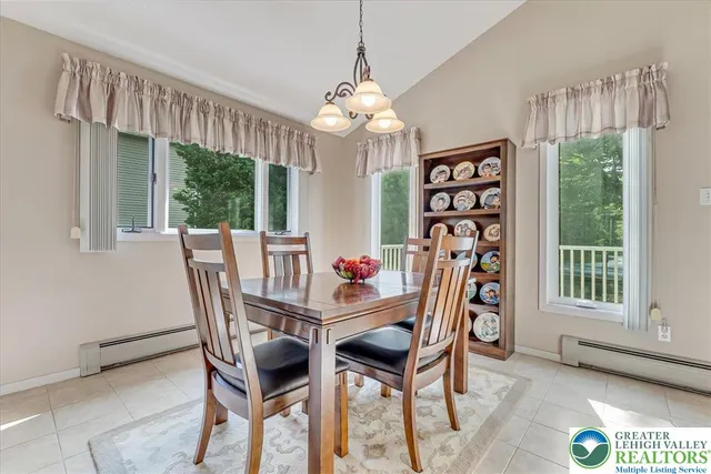 a dining room with furniture a chandelier and wooden floor
