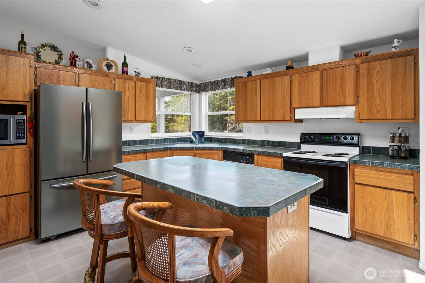155 Airport Perimeter Way Decatur Island, WA 98221 - Photo 11 of 26 a kitchen with stainless steel appliances granite countertop a refrigerator a sink a stove and a refrigerator