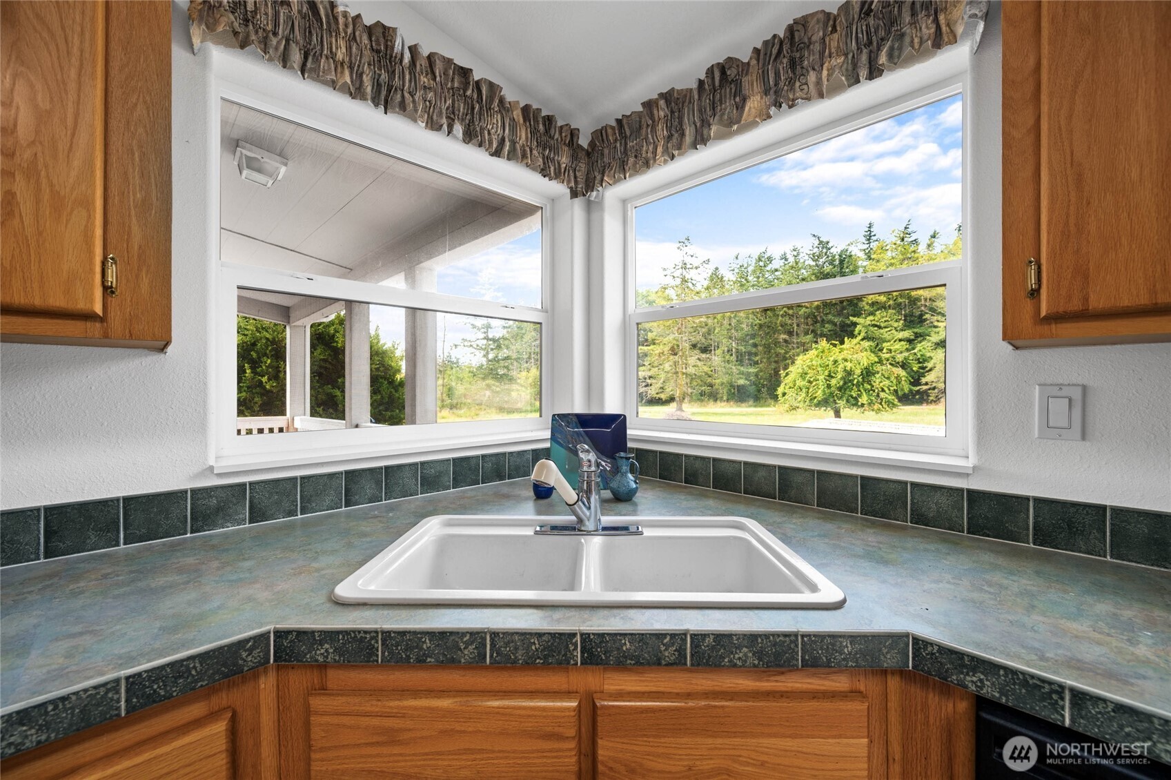 155 Airport Perimeter Way Decatur Island, WA 98221 - Photo 12 of 26 a kitchen with sink a window and cabinets