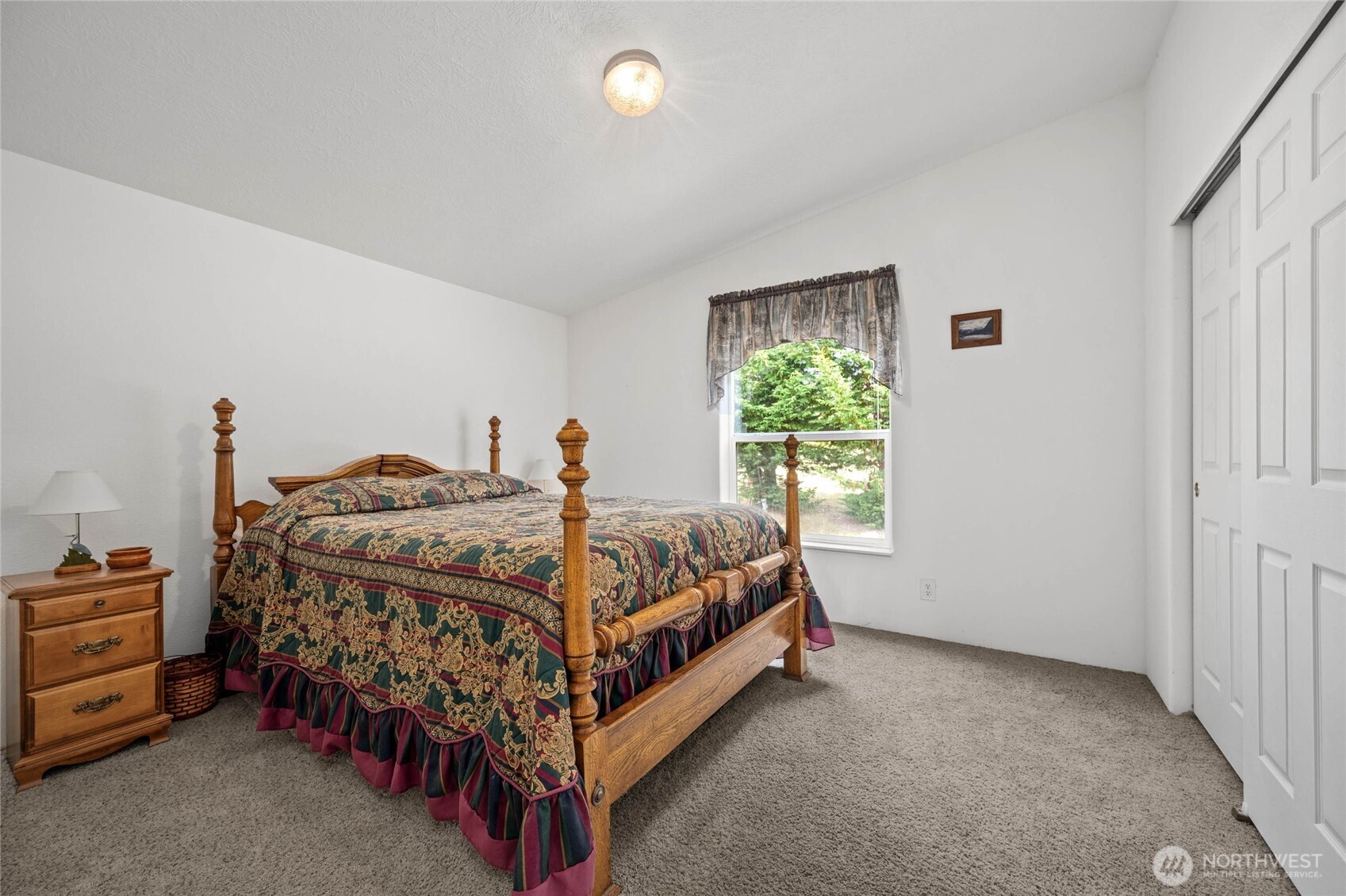 155 Airport Perimeter Way Decatur Island, WA 98221 - Photo 14 of 26 a bed sitting in a bedroom next to a window