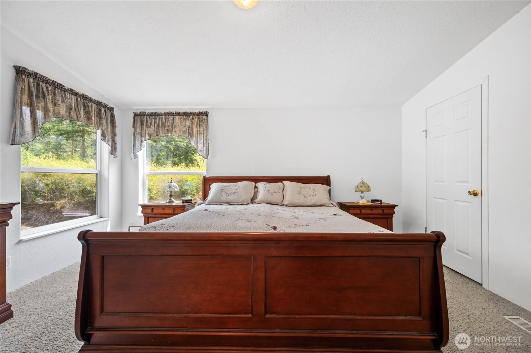 155 Airport Perimeter Way Decatur Island, WA 98221 - Photo 18 of 26 a bedroom with a bed and a window