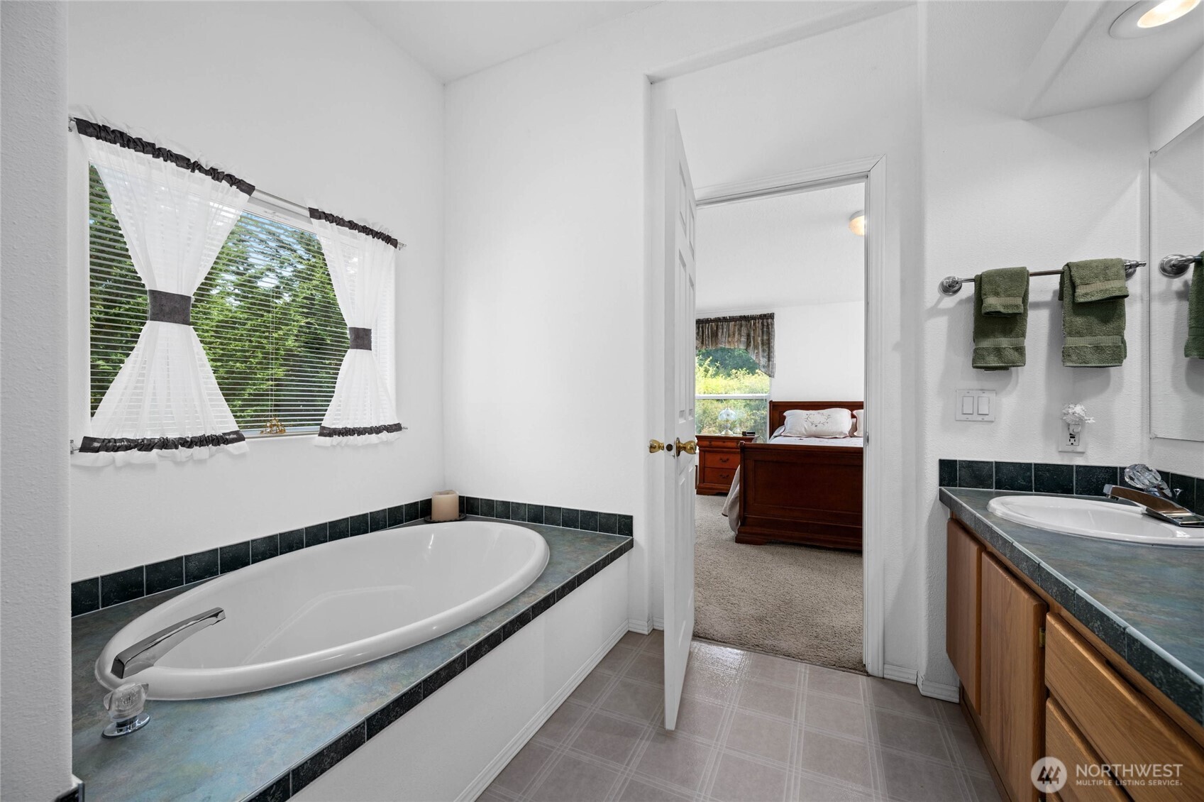 155 Airport Perimeter Way Decatur Island, WA 98221 - Photo 19 of 26 a bathroom with a granite countertop tub and a sink