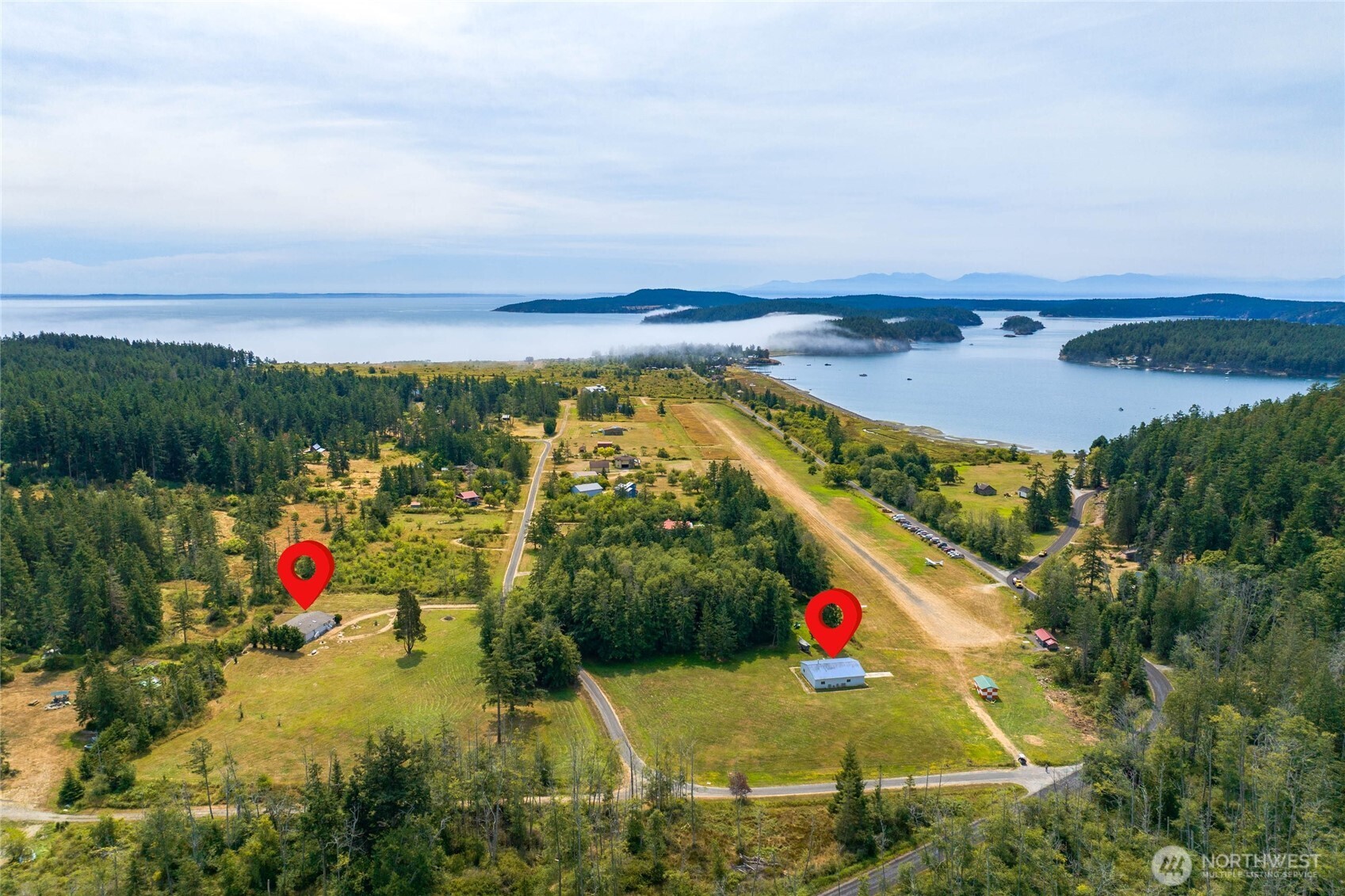 155 Airport Perimeter Way Decatur Island, WA 98221 - Photo 25 of 26 an aerial view of residential houses with outdoor space and trees