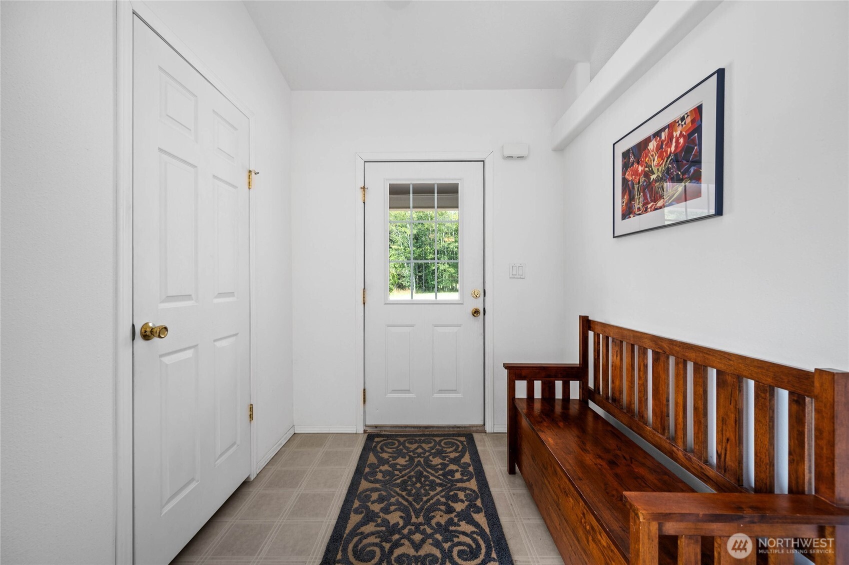 155 Airport Perimeter Way Decatur Island, WA 98221 - Photo 4 of 26 a hallway with wooden floor closet and windows