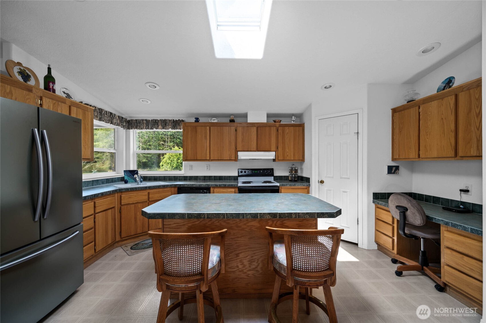 155 Airport Perimeter Way Decatur Island, WA 98221 - Photo 10 of 26 a kitchen with stainless steel appliances granite countertop a kitchen island a stove a table and chairs in it