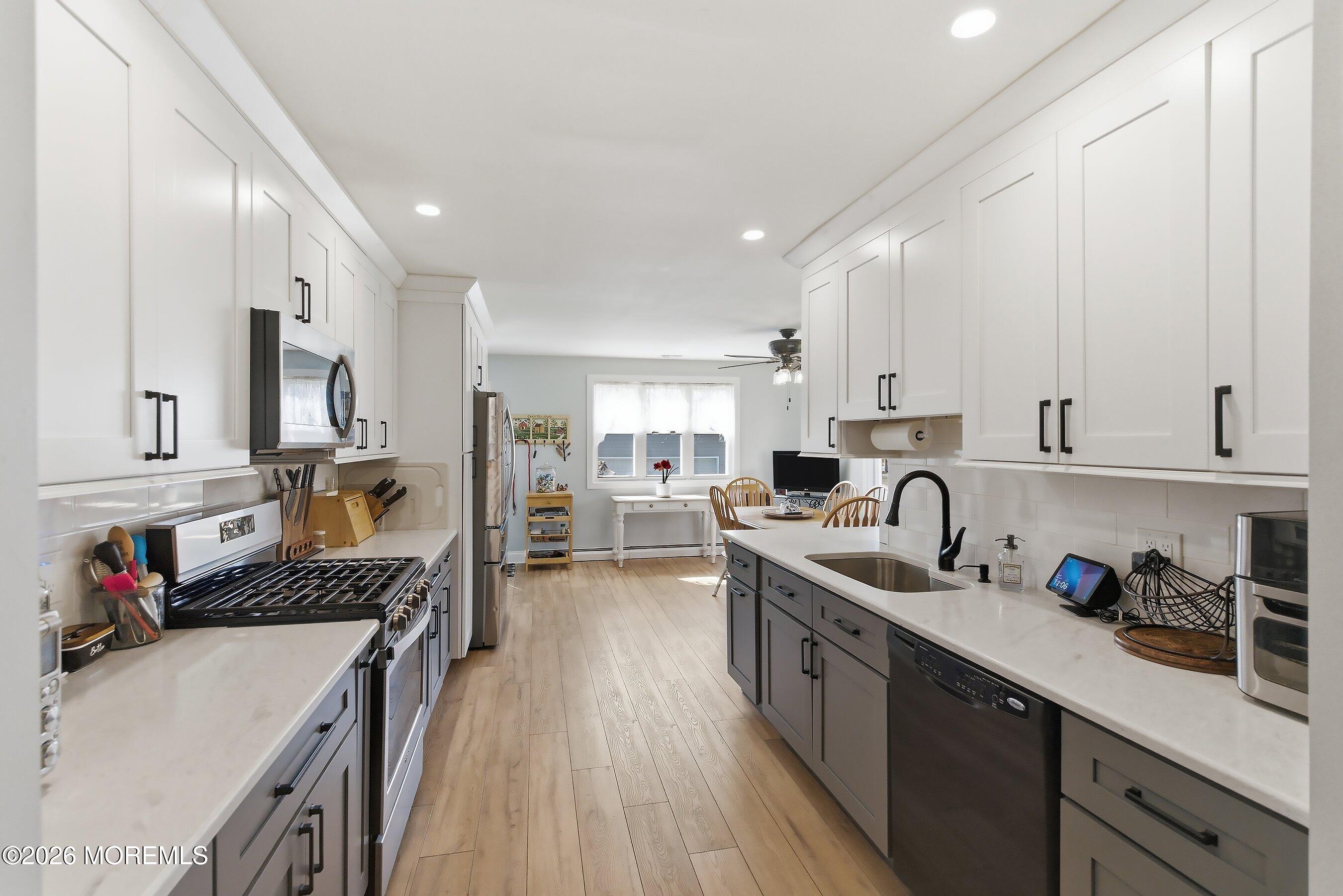 745 Oak Glen Road Howell, NJ 07731 - Photo 14 of 46 a kitchen with a sink stove top oven and cabinets
