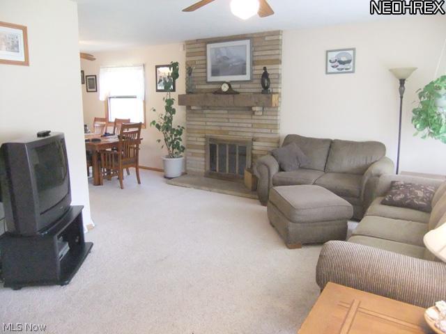 6468 South Cleveland Massillon Road Clinton, OH 44216 - Photo 6 of 25 The beautiful stone gas fireplace is located between the dining room and living room.