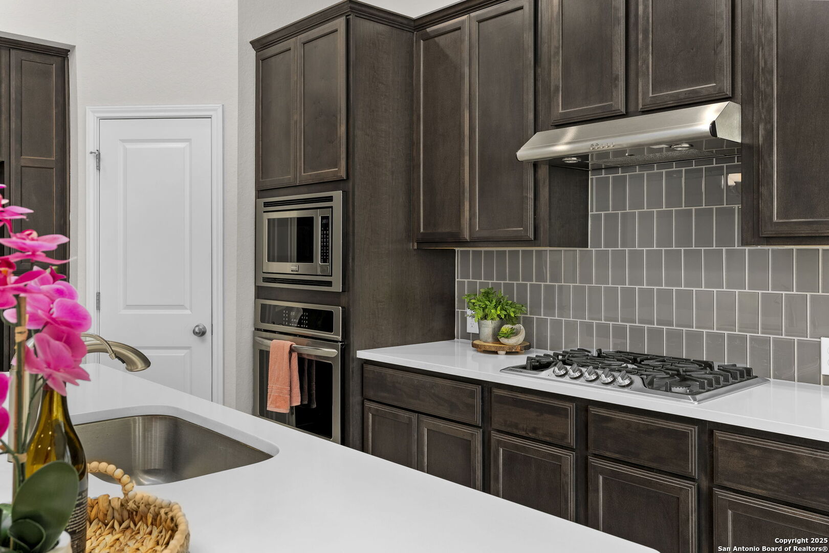 9753 Monken Boerne, TX 78006 - Photo 11 of 38 a kitchen with stainless steel appliances kitchen island granite countertop a sink stove and refrigerator