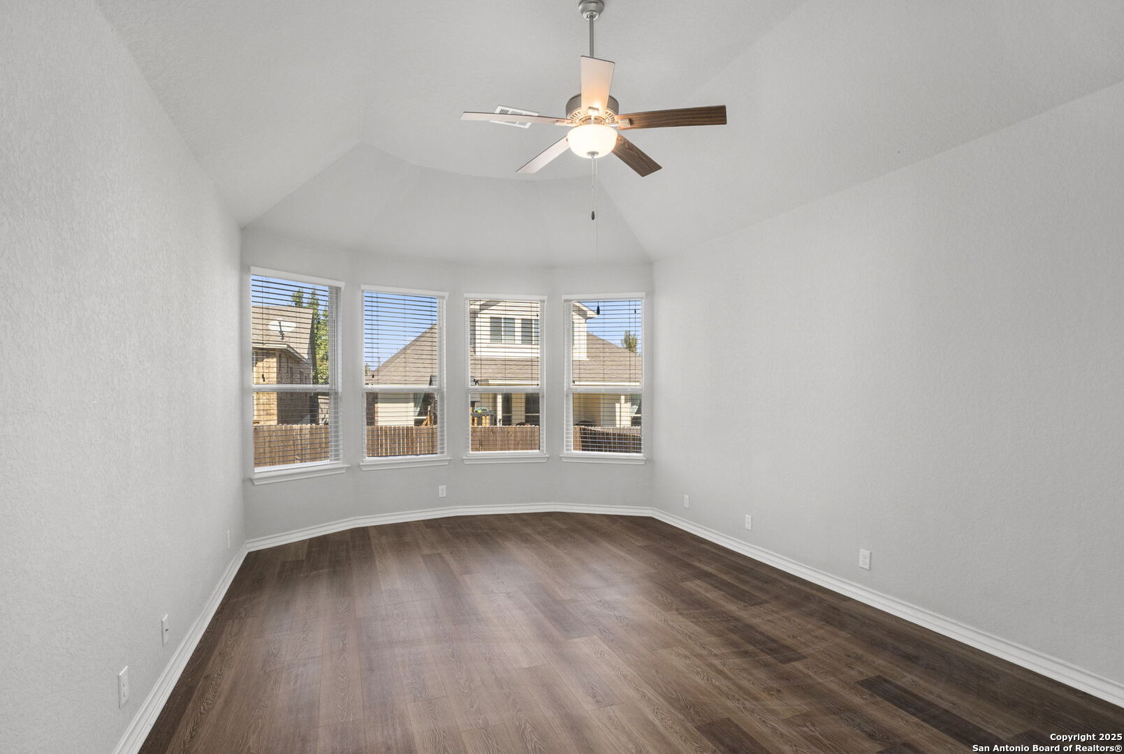 9753 Monken Boerne, TX 78006 - Photo 13 of 38 an empty room with wooden floor fan and windows