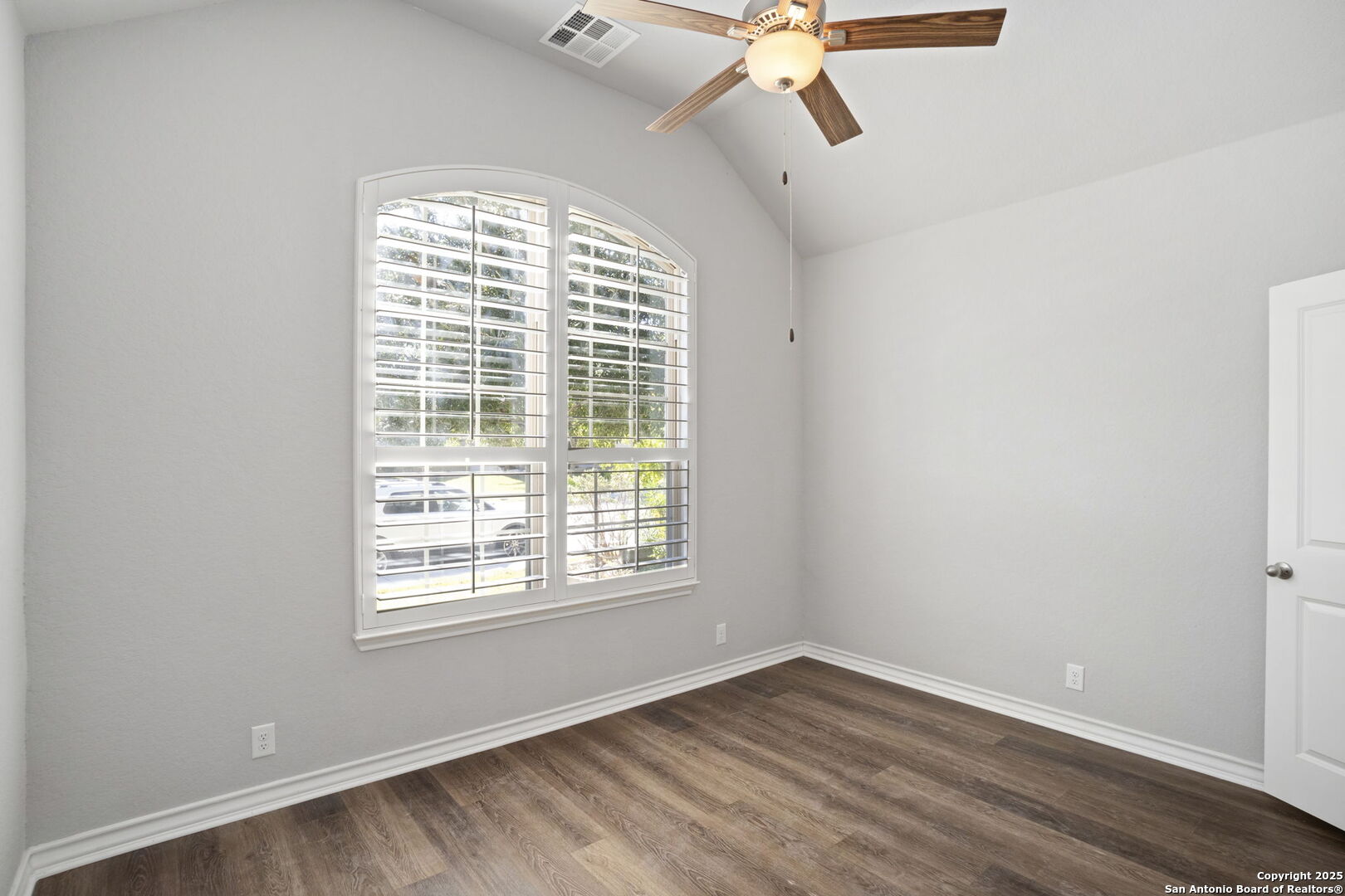 9753 Monken Boerne, TX 78006 - Photo 24 of 38 an empty room with wooden floor fan and windows