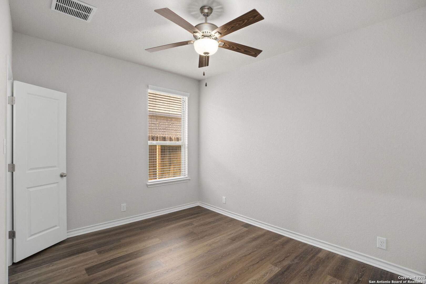 9753 Monken Boerne, TX 78006 - Photo 27 of 38 an empty room with wooden floor closet and fan