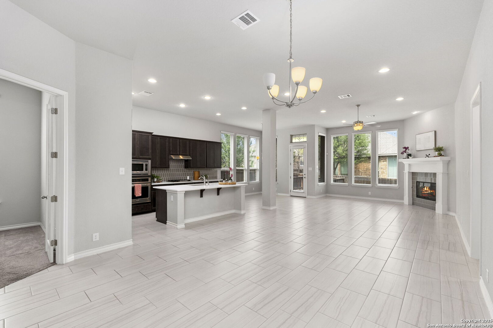 9753 Monken Boerne, TX 78006 - Photo 3 of 38 a view of a kitchen with kitchen island stainless steel appliances sink cabinets and stove top oven