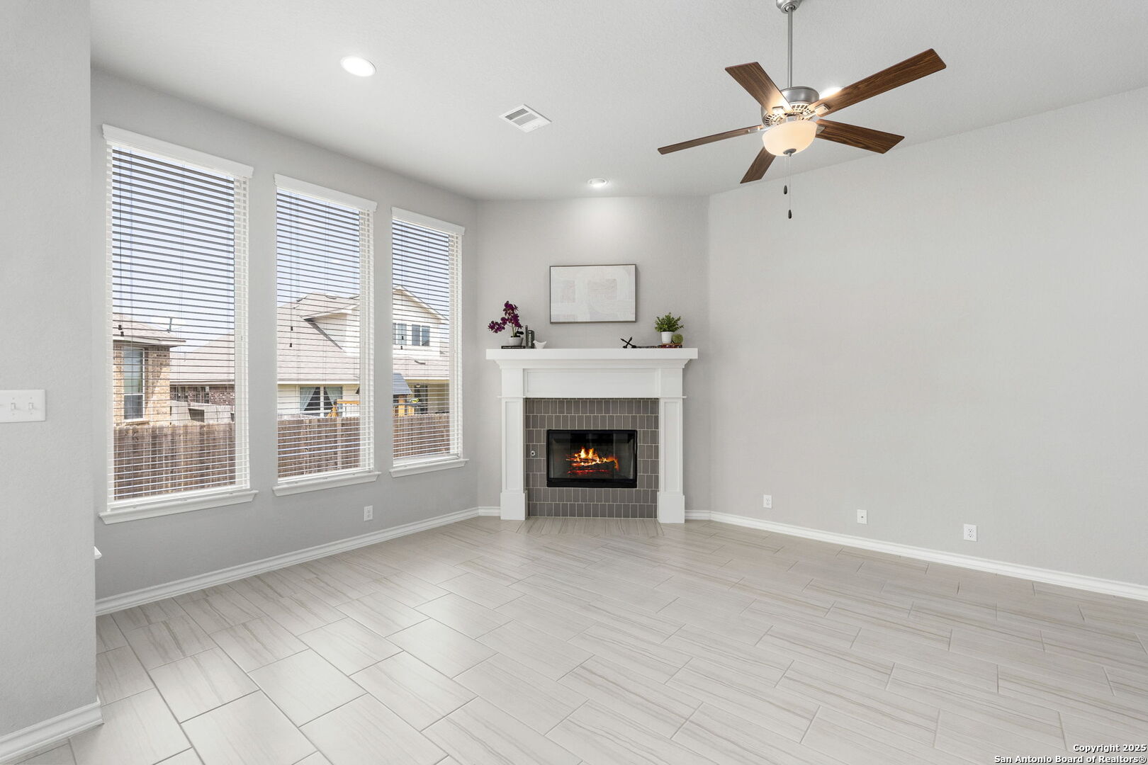 9753 Monken Boerne, TX 78006 - Photo 5 of 38 a view of an empty room with a fireplace and a window