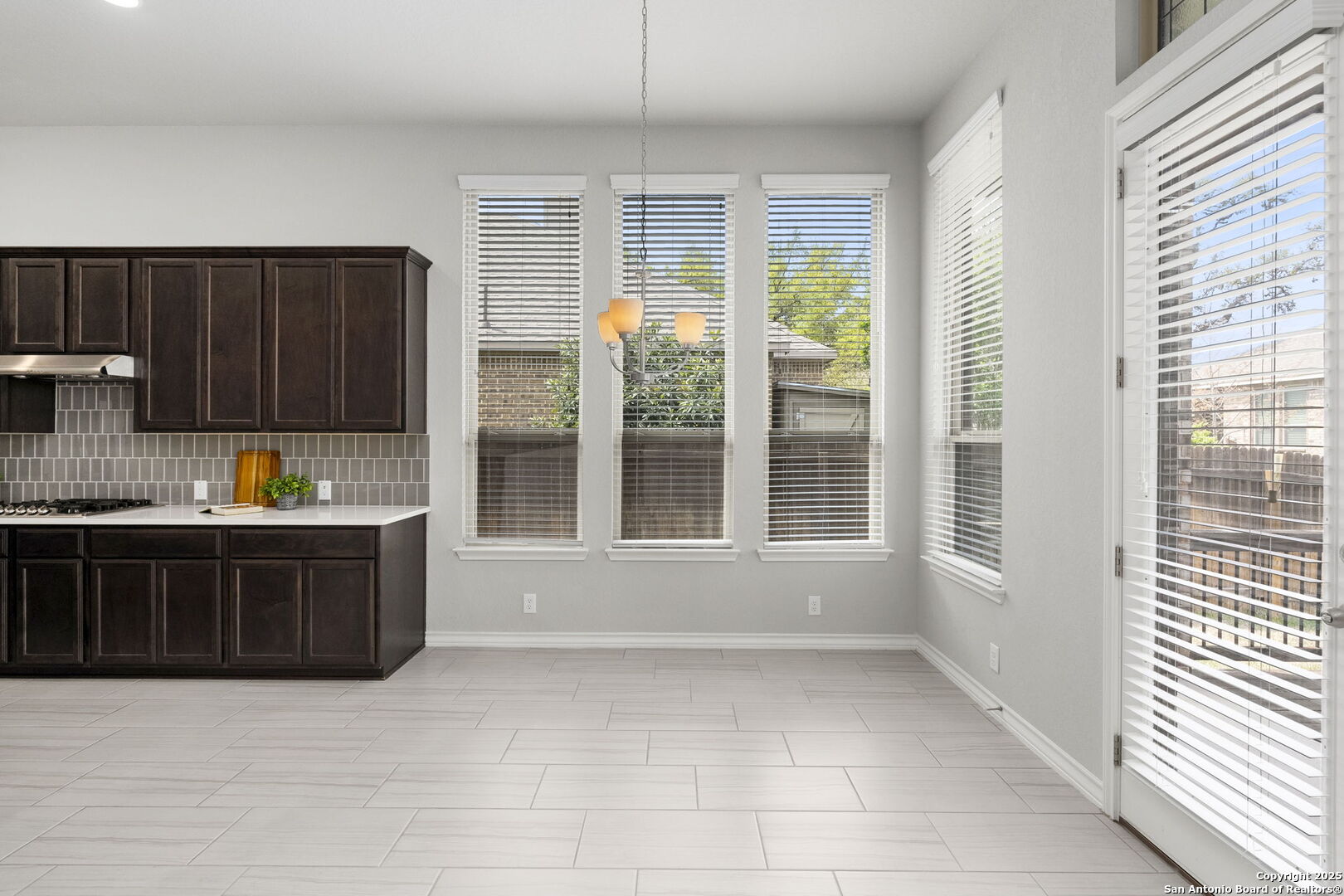 9753 Monken Boerne, TX 78006 - Photo 7 of 38 a large kitchen with granite countertop a stove a sink and a refrigerator