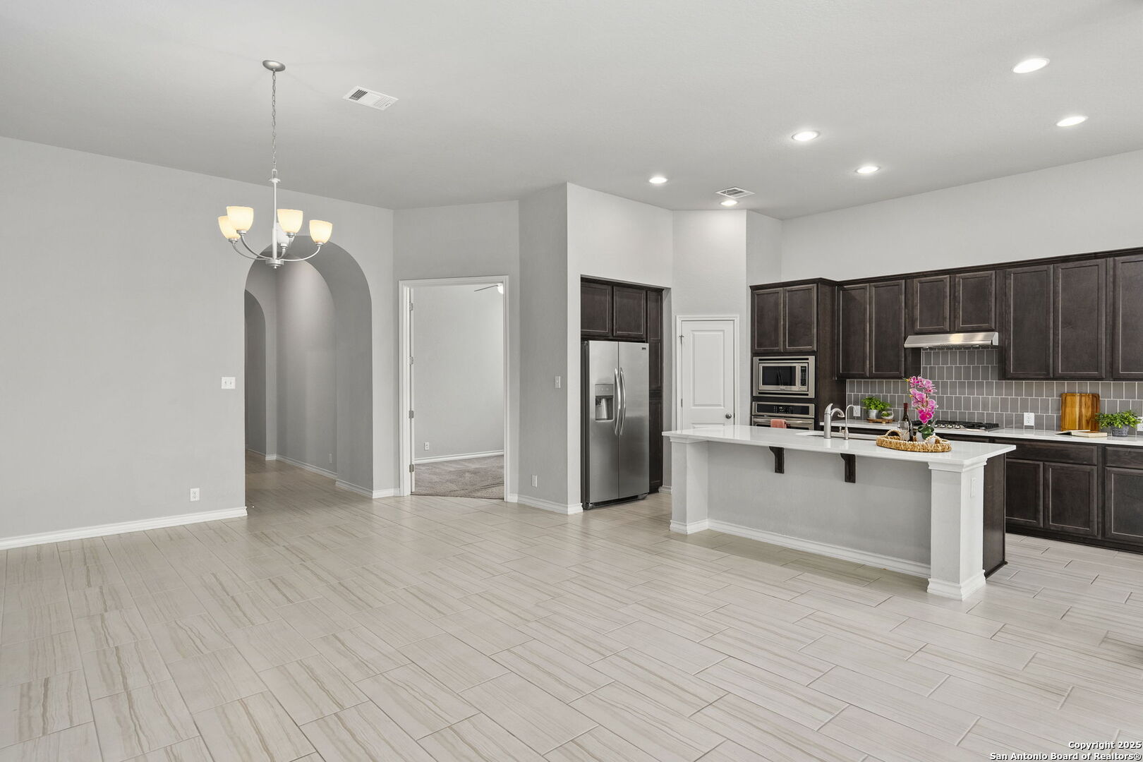 9753 Monken Boerne, TX 78006 - Photo 8 of 38 a kitchen with stainless steel appliances a refrigerator sink and microwave