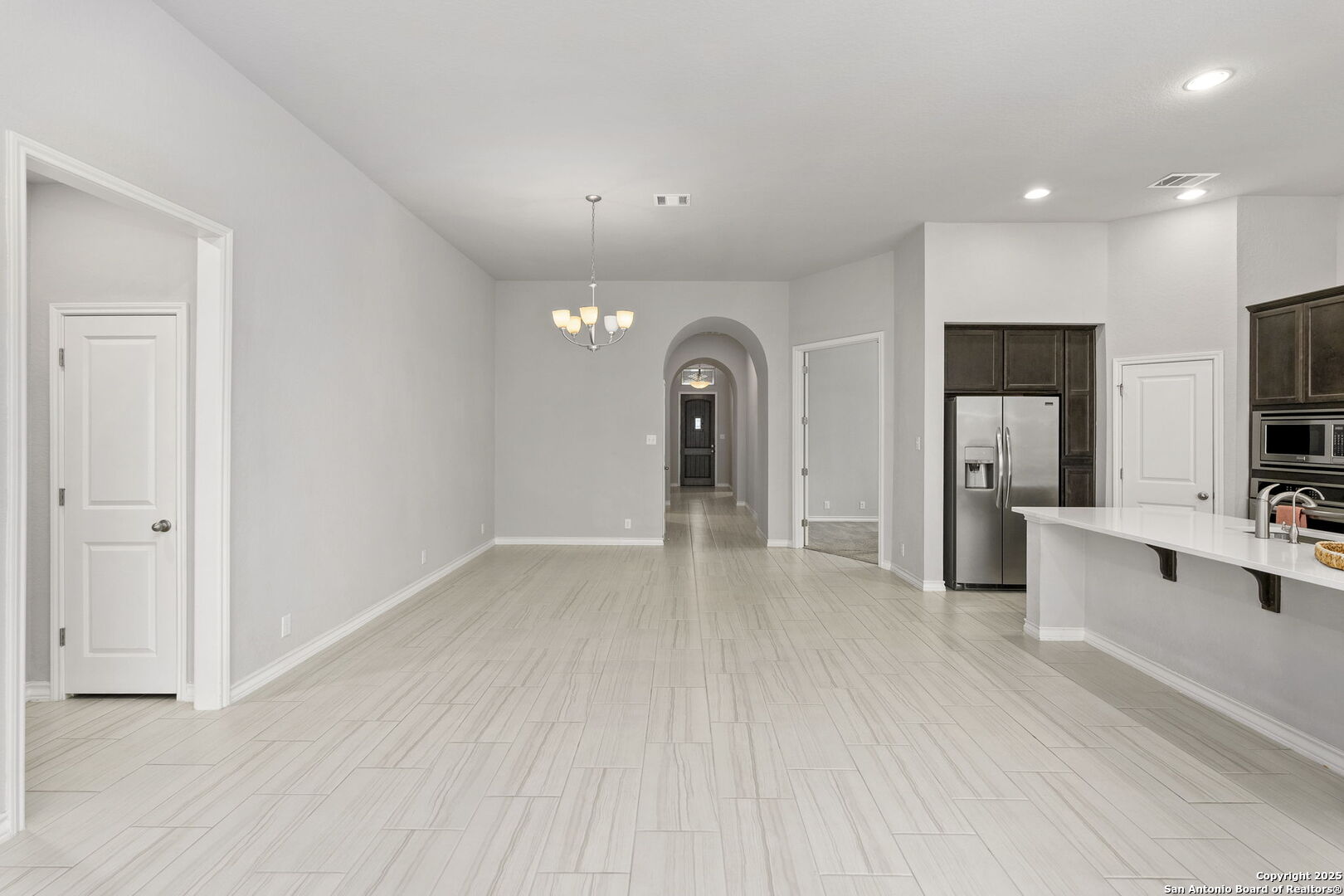 9753 Monken Boerne, TX 78006 - Photo 9 of 38 a view of a big room with kitchen view and wooden floor