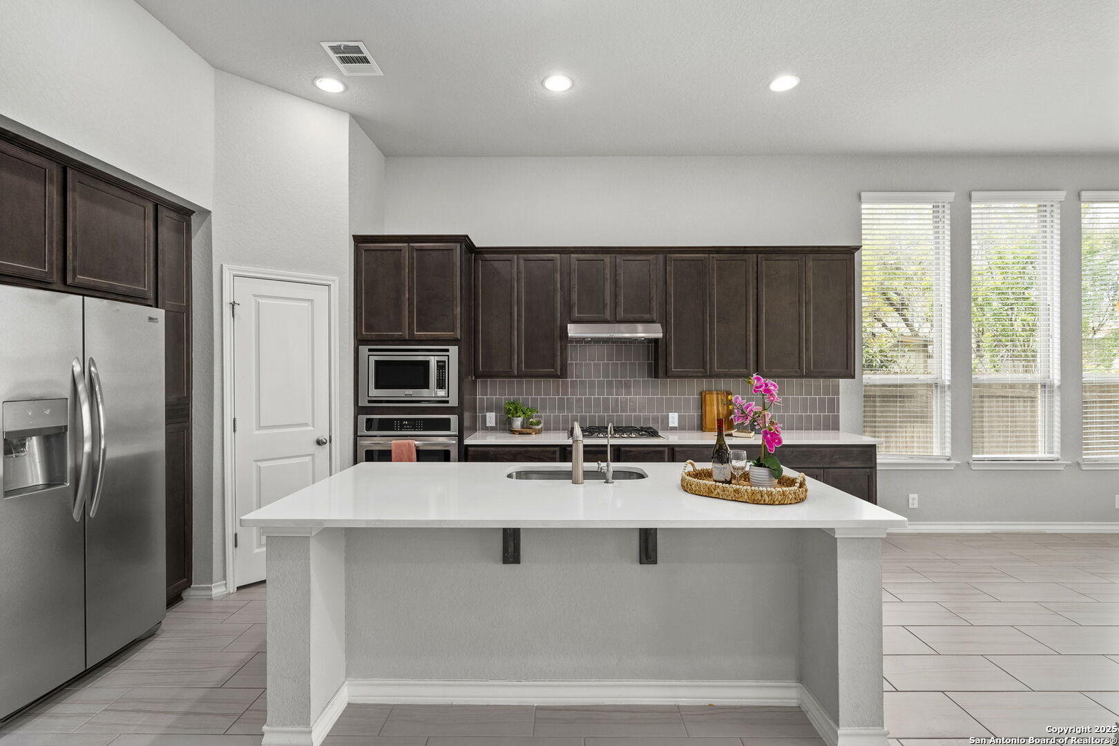9753 Monken Boerne, TX 78006 - Photo 10 of 38 a kitchen with stainless steel appliances a refrigerator sink and wooden cabinets