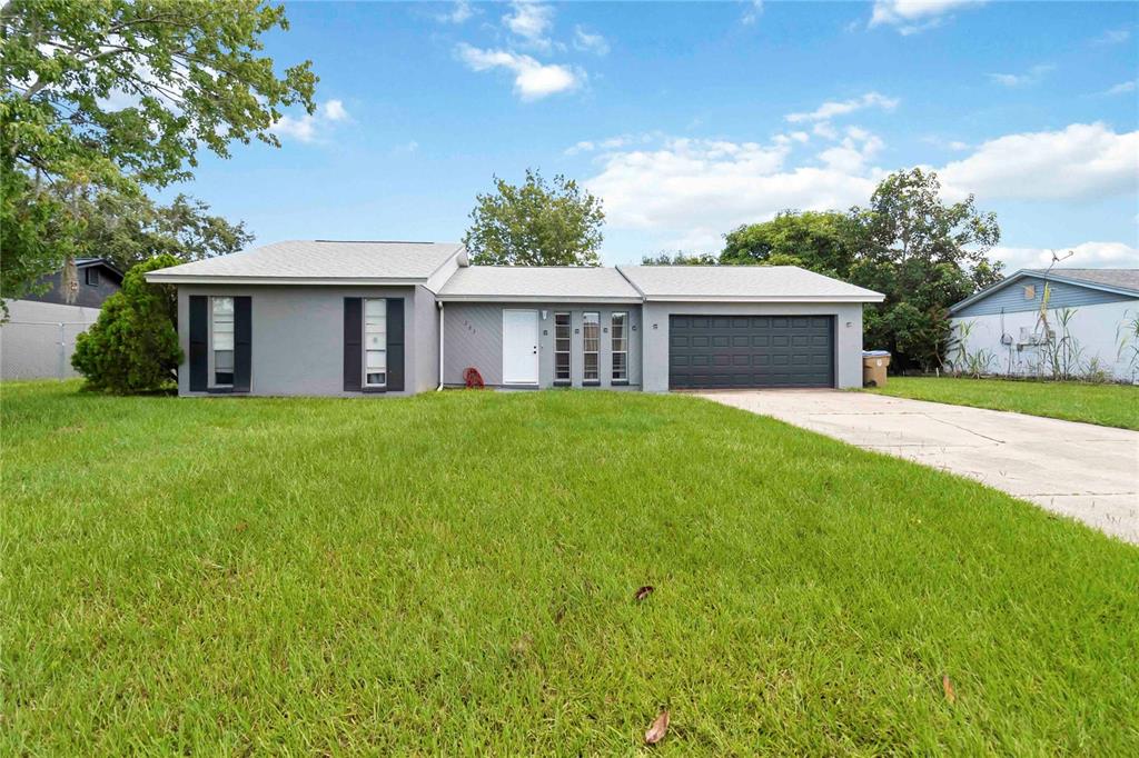283 Gardenia Road Kissimmee, FL 34743 - Photo 1 of 1 a view of a house with a yard and a porch