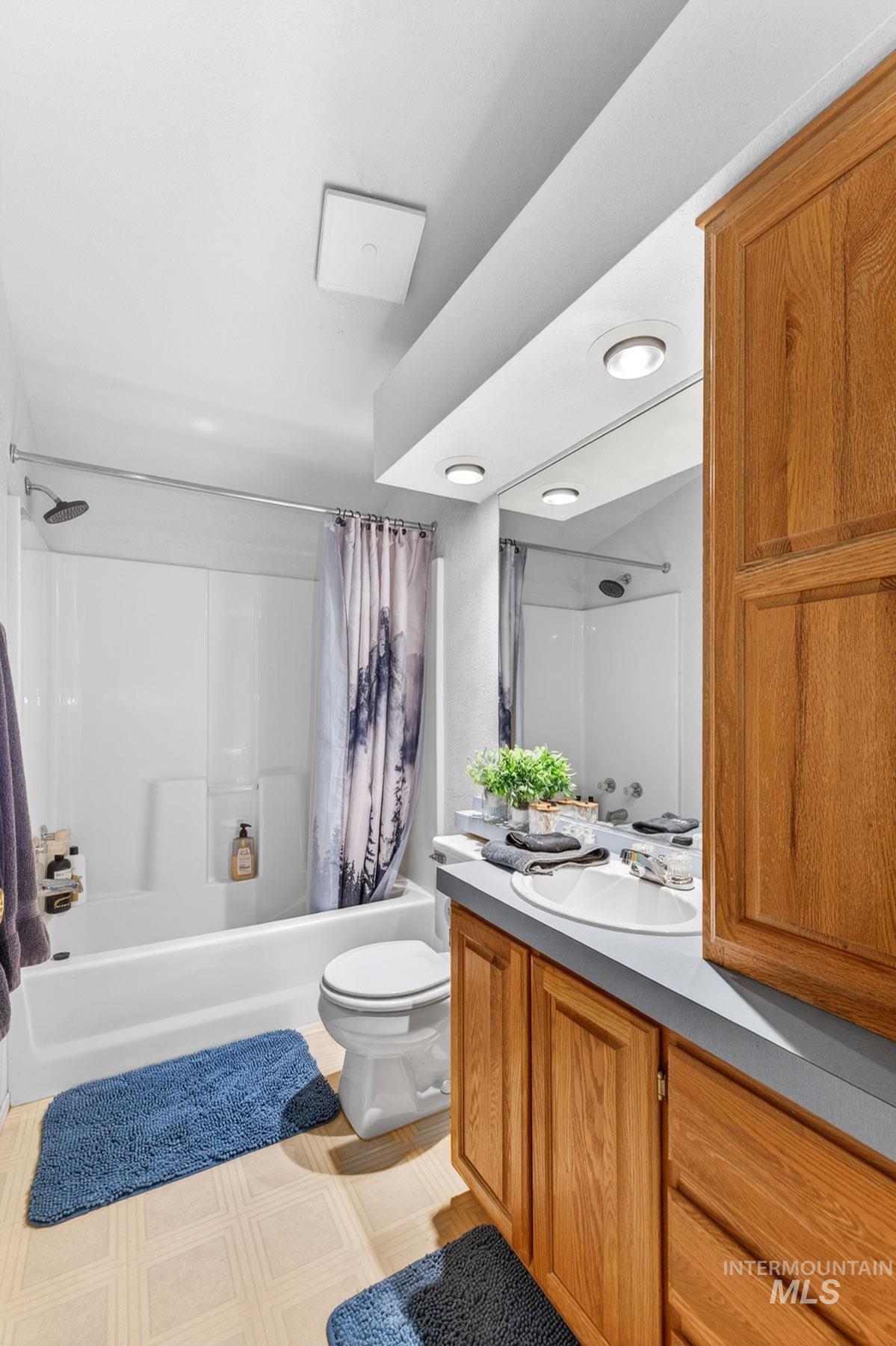 151 Cow Creek Road Lucile, ID 83542 - Photo 32 of 50 Bathroom featuring a white tub-shower combination with a chrome shower head and a built-in shelf